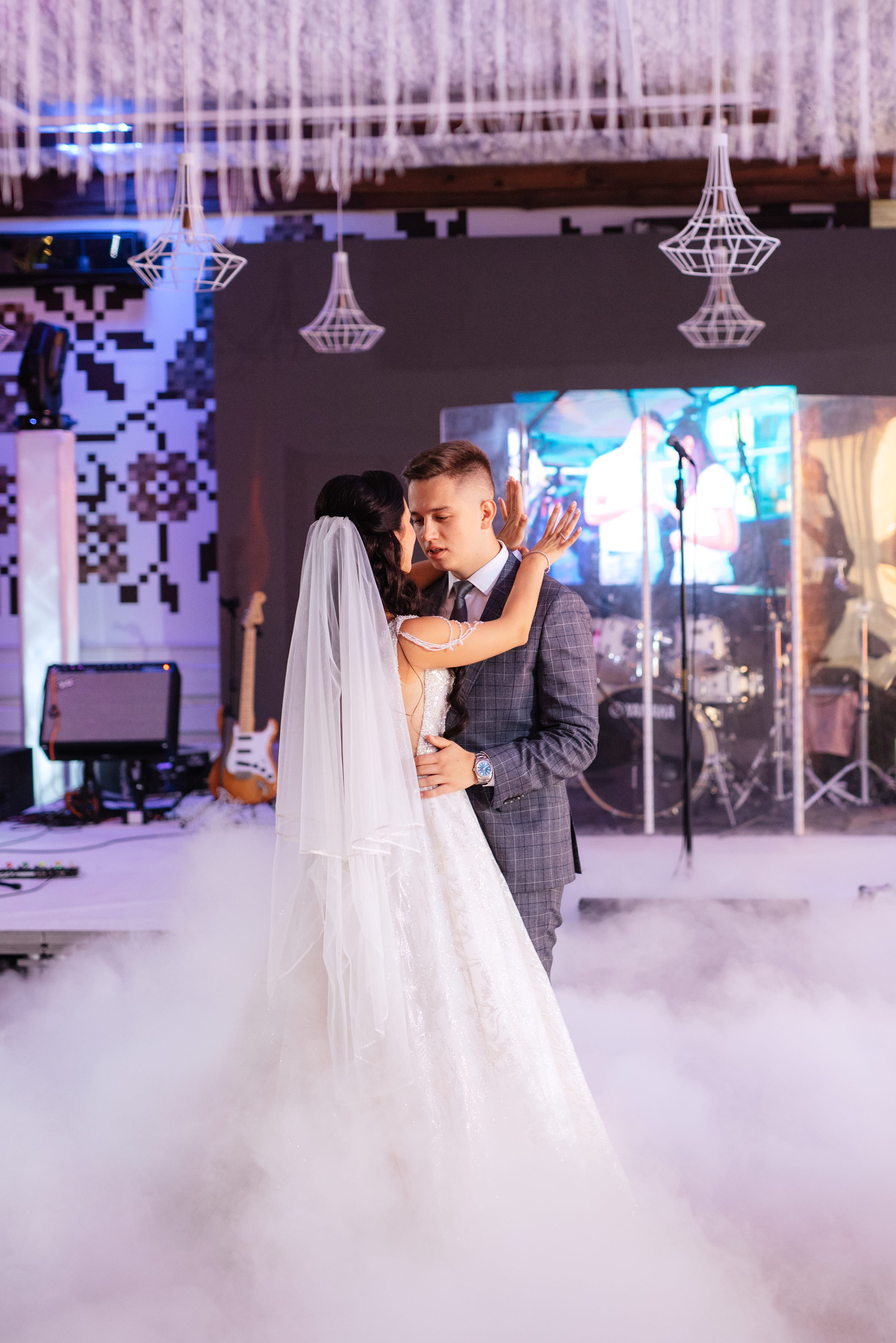 Newlyweds sharing their first dance while a live band performs
